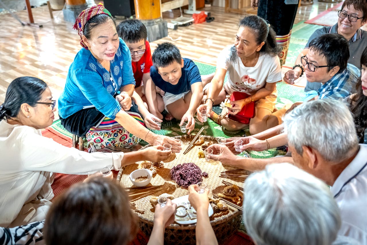 A diverse group sharing a traditional meal, highlighting cultural traditions indoors.